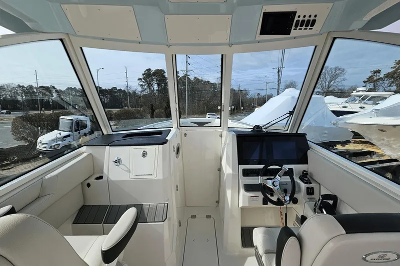  Yacht Photos Pics 2023 Sailfish 316 DC boat interior with modern helm and seating.
