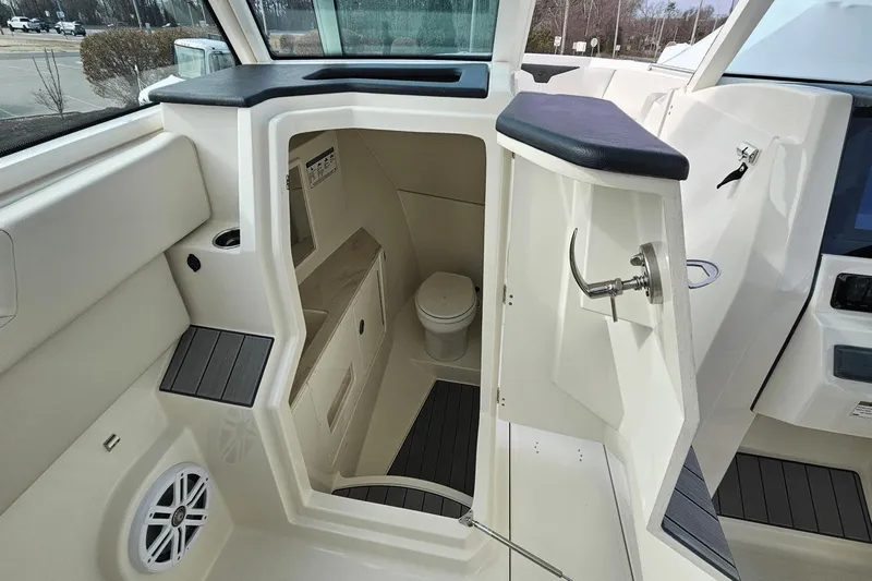  Yacht Photos Pics 2023 Sailfish 316 DC boat interior with compact bathroom and modern amenities.