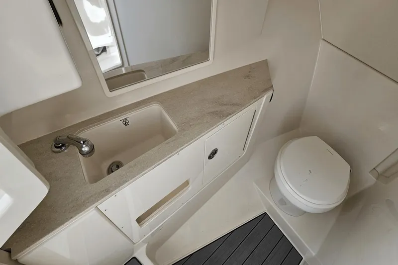 Yacht Photos Pics 2023 Sailfish 316 DC boat bathroom with sink, mirror, and toilet.