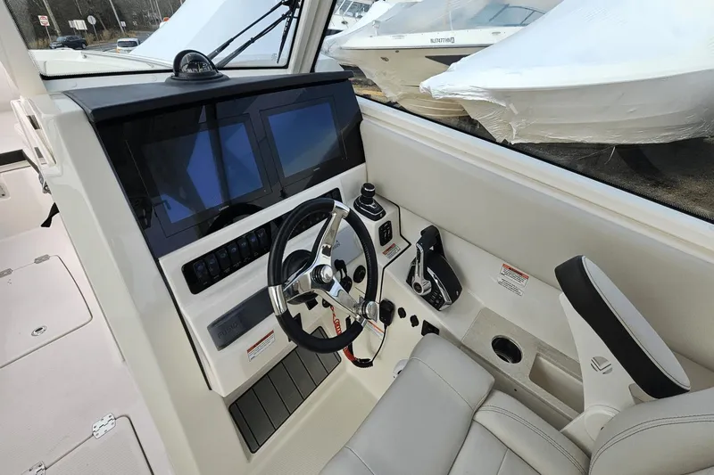  Yacht Photos Pics 2023 Sailfish 316 DC boat cockpit with modern steering and dual screens.