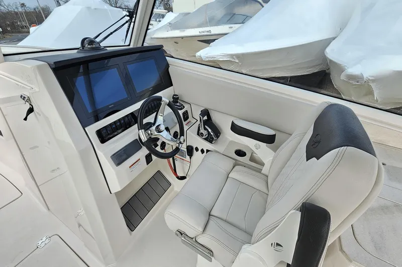  Yacht Photos Pics 2023 Sailfish 316 DC boat cockpit with modern steering and dual screens.