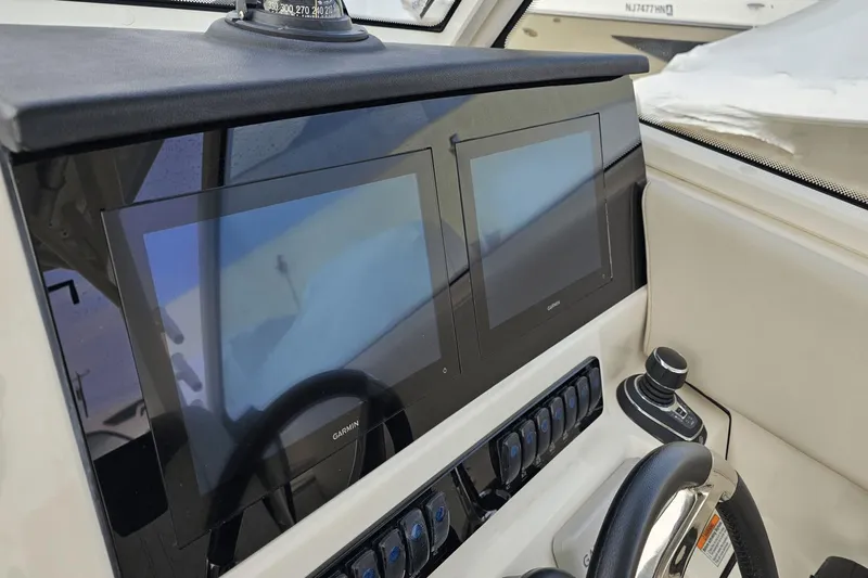  Yacht Photos Pics 2023 Sailfish 316 DC dashboard with dual Garmin displays and joystick control.
