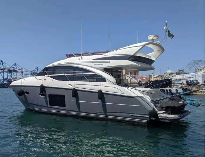  Yacht Photos Pics 2014 Princess 52 Flybridge yacht docked in a marina, under clear blue skies.
