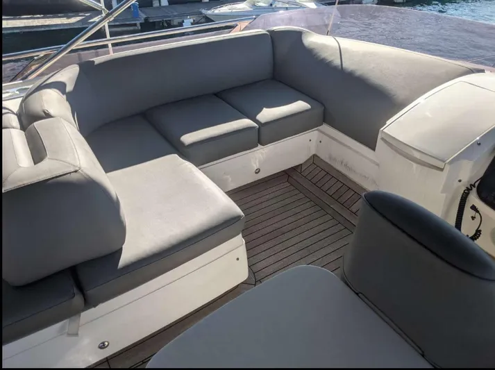  Yacht Photos Pics Luxurious seating area on 2014 Princess 52 Flybridge yacht with gray cushions.