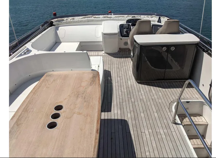  Yacht Photos Pics Flybridge of 2014 Princess 52 yacht with seating, table, and helm, overlooking the ocean.