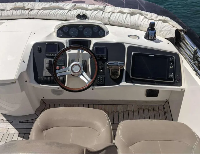  Yacht Photos Pics Flybridge helm of 2014 Princess 52 yacht with steering wheel and navigation equipment.
