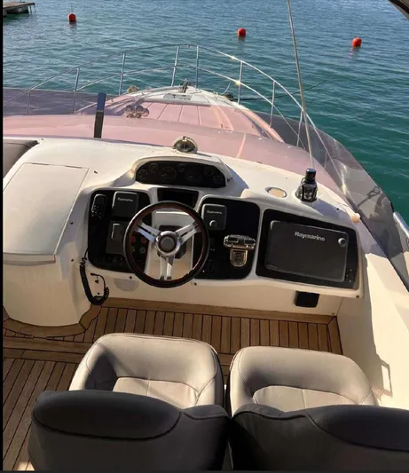  Yacht Photos Pics Flybridge helm of 2014 Princess 52 yacht with dual seats and navigation equipment.