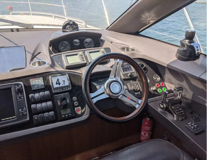  Yacht Photos Pics Helm of 2014 Princess 52 Flybridge yacht with modern controls and steering wheel.