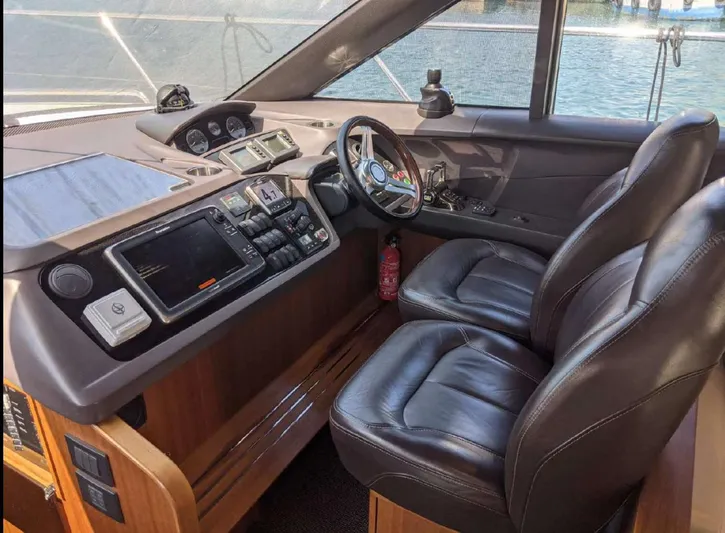  Yacht Photos Pics Helm of 2014 Princess 52 Flybridge yacht with leather seats and modern navigation equipment.