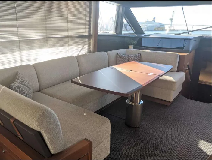  Yacht Photos Pics Luxurious interior of 2014 Princess 52 Flybridge yacht with elegant seating and table.