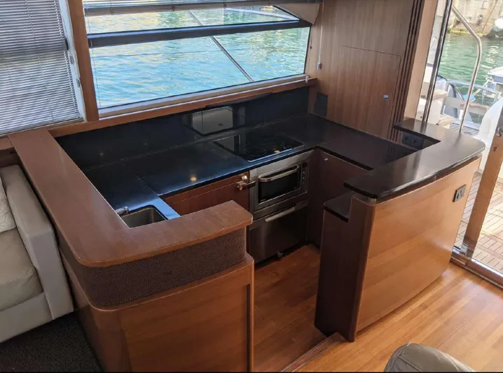  Yacht Photos Pics Luxurious kitchen interior of 2014 Princess 52 Flybridge yacht with modern appliances.
