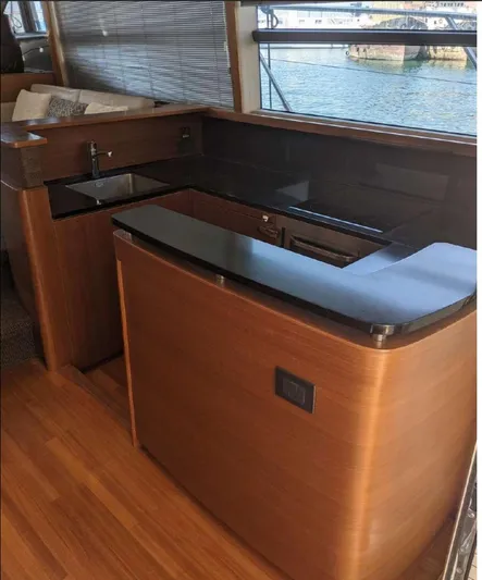  Yacht Photos Pics Luxurious kitchen area on 2014 Princess 52 Flybridge yacht with sleek wood finish.
