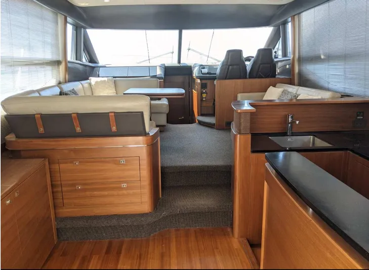  Yacht Photos Pics Luxurious interior of 2014 Princess 52 Flybridge yacht with modern seating and kitchenette.