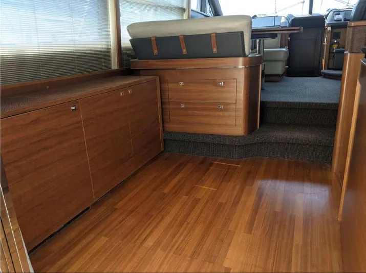  Yacht Photos Pics Interior of 2014 Princess 52 Flybridge yacht with wooden flooring and seating area.