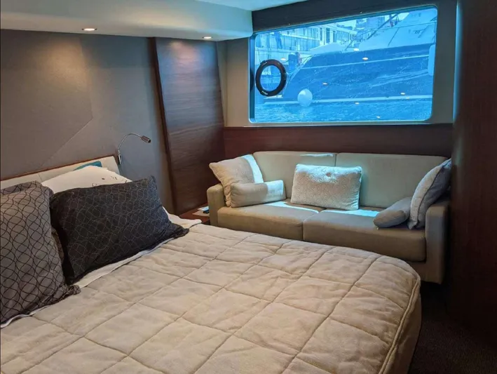  Yacht Photos Pics Luxurious cabin interior of 2014 Princess 52 Flybridge yacht with bed and sofa.
