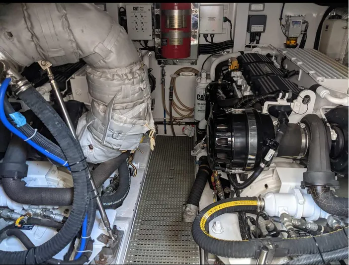  Yacht Photos Pics Engine room of a 2014 Princess 52 Flybridge yacht, showcasing detailed machinery and components.