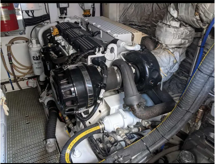  Yacht Photos Pics Engine room of a 2014 Princess 52 Flybridge yacht, showcasing detailed machinery and components.
