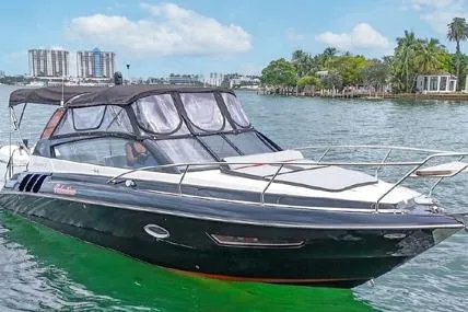  Yacht Photos Pics 2024 Hanover 305 Sport Edition boat cruising on a sunny day with cityscape background.