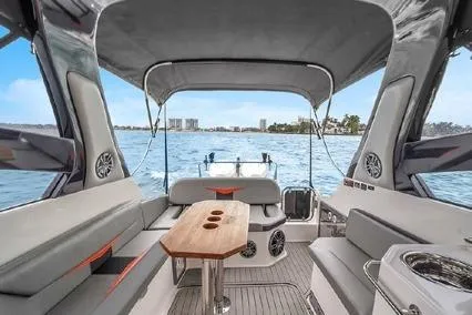  Yacht Photos Pics 2024 Hanover 305 Sport Edition boat interior with seating and table, overlooking water.