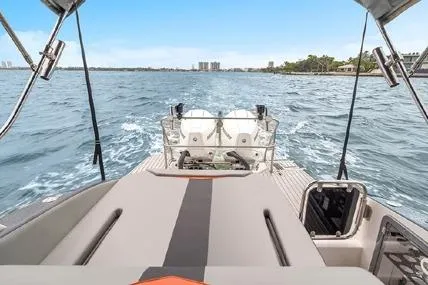  Yacht Photos Pics 2024 Hanover 305 Sport Edition boat cruising on open water, showcasing sleek design and spacious deck.