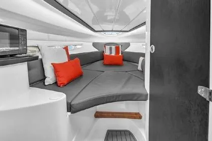  Yacht Photos Pics 2024 Hanover 305 Sport Edition cabin with modern interior, gray seating, and vibrant red cushions.