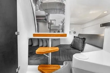  Yacht Photos Pics 2024 Hanover 305 Sport Edition interior with modern seating and wooden accents.