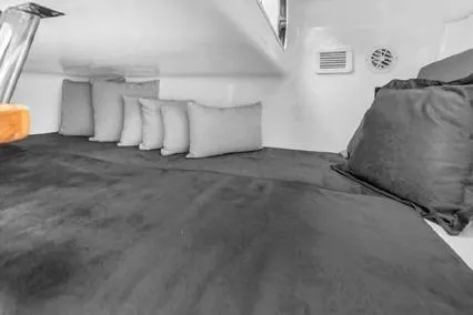  Yacht Photos Pics 2024 Hanover 305 Sport Edition interior cabin with plush bedding and cushions.