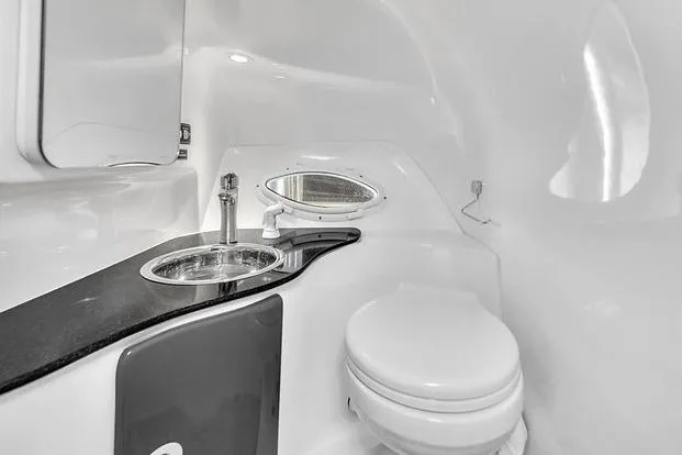  Yacht Photos Pics 2024 Hanover 305 Sport Edition bathroom with sleek sink and compact toilet design.