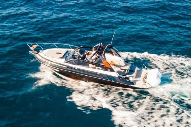  Yacht Photos Pics 2024 Hanover 305 Sport Edition boat cruising on open blue water.