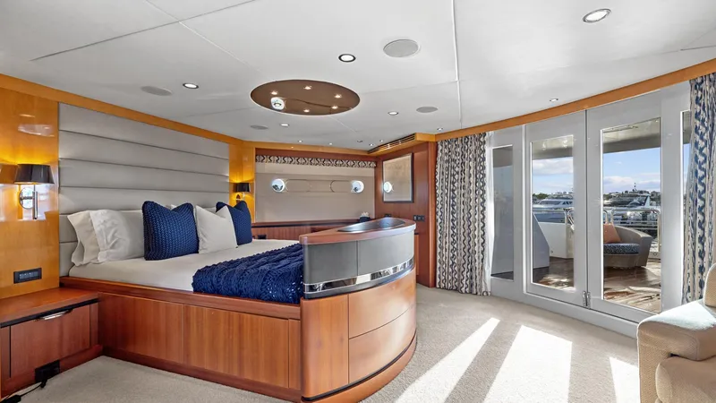 My Spirit Yacht Photos Pics Luxurious yacht bedroom with modern design, featuring large windows and elegant furnishings.