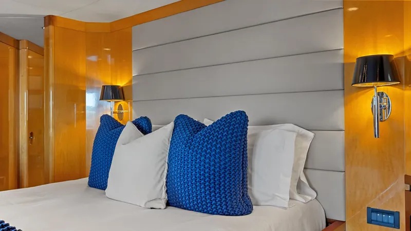 My Spirit Yacht Photos Pics Luxurious yacht bedroom with blue pillows, modern lighting, and wooden accents, New Zealand Yachts Wave Piercer 2005.