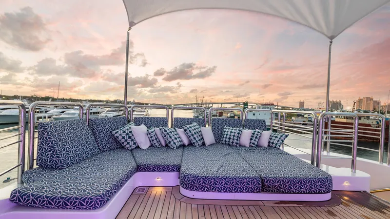 My Spirit Yacht Photos Pics Luxurious 2005 New Zealand Yachts Wave Piercer deck with patterned cushions at sunset.