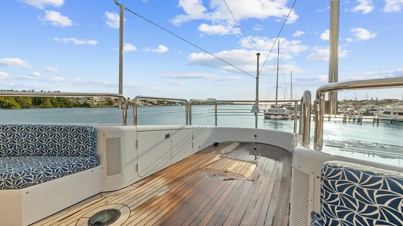 My Spirit Yacht Photos Pics Luxury yacht deck with patterned seating, wooden flooring, and scenic waterfront view. New Zealand Yachts Wave Piercer 2005.