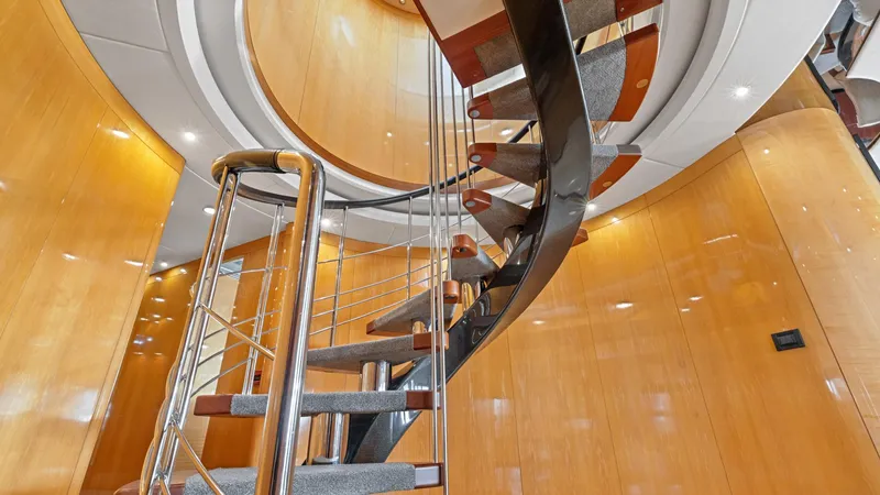 My Spirit Yacht Photos Pics Spiral staircase inside 2005 New Zealand Yachts Wave Piercer, featuring sleek wooden and metal design.