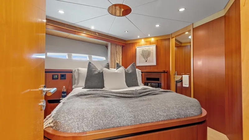 My Spirit Yacht Photos Pics Luxurious bedroom interior of 2005 New Zealand Yachts Wave Piercer, featuring elegant wood finishes.