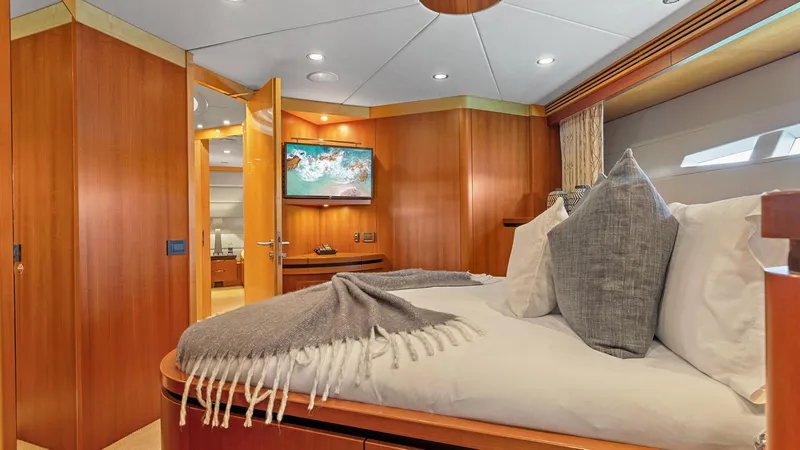 My Spirit Yacht Photos Pics Luxurious 2005 New Zealand Yachts Wave Piercer bedroom with elegant wood paneling and cozy bedding.