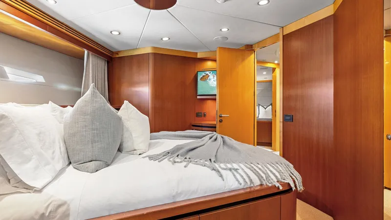 My Spirit Yacht Photos Pics Luxurious bedroom interior of 2005 New Zealand Yachts Wave Piercer, featuring elegant wood paneling.