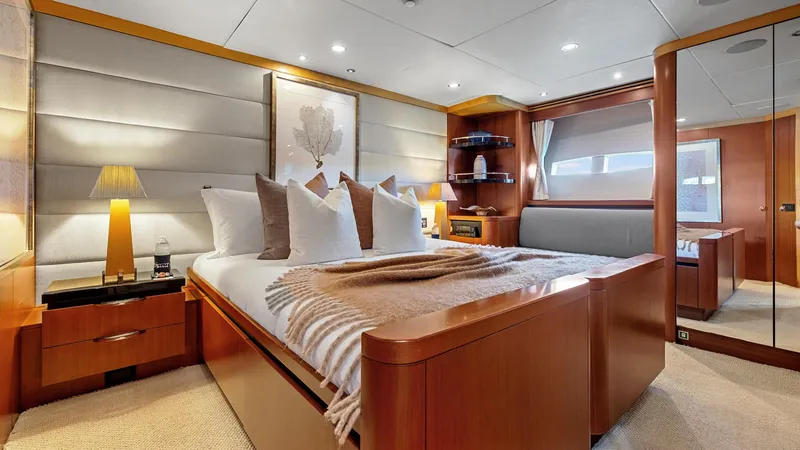 My Spirit Yacht Photos Pics Luxurious bedroom interior of 2005 New Zealand Yachts Wave Piercer, featuring elegant wood finishes.