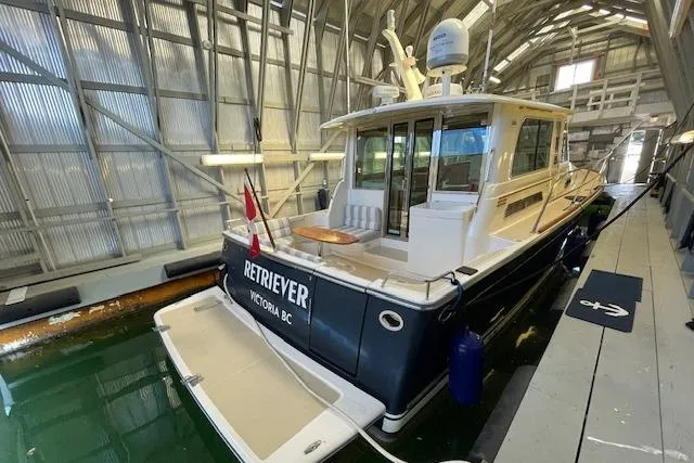  Yacht Photos Pics 2014 Sabre 42 Salon Express yacht docked indoors, featuring a sleek design and Canadian flag.