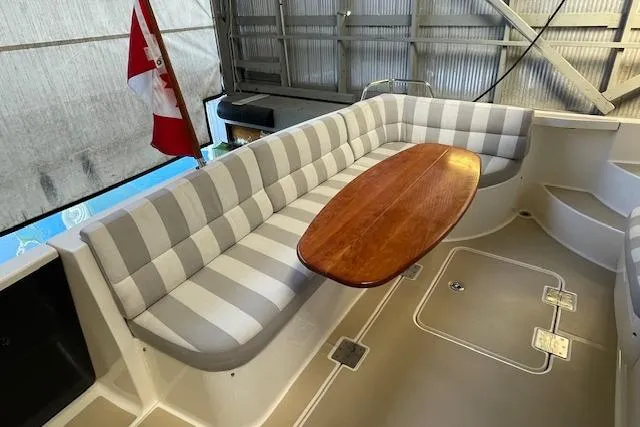  Yacht Photos Pics 2014 Sabre 42 Salon Express interior with striped seating and wooden table.