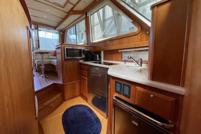  Yacht Photos Pics 2014 Sabre 42 Salon Express yacht interior with modern kitchen and wood finishes.