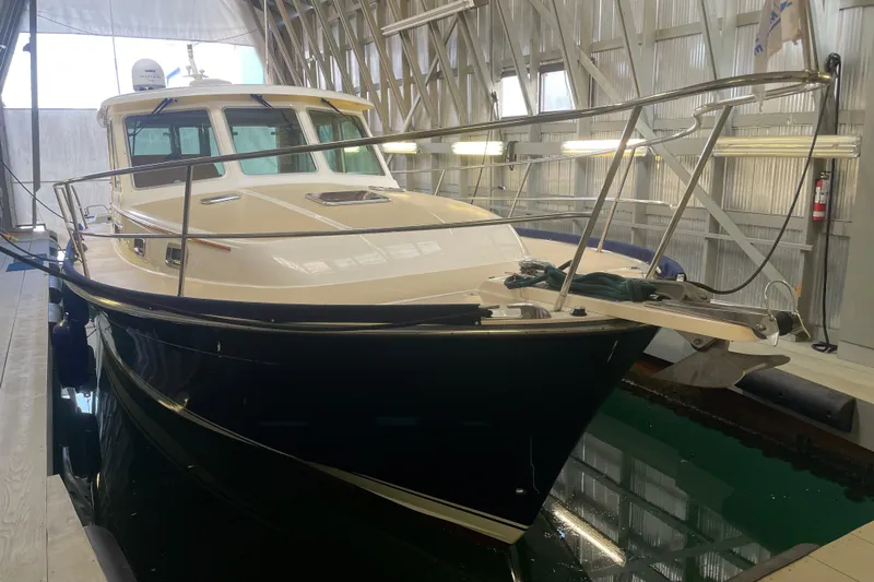  Yacht Photos Pics 2014 Sabre 42 Salon Express yacht docked in a covered marina.