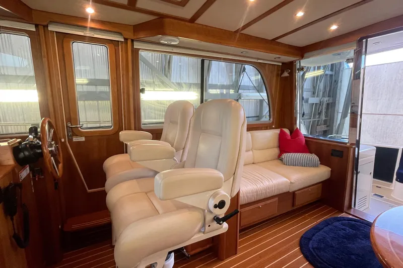  Yacht Photos Pics Luxurious interior of 2014 Sabre 42 Salon Express with plush seating and wooden accents.