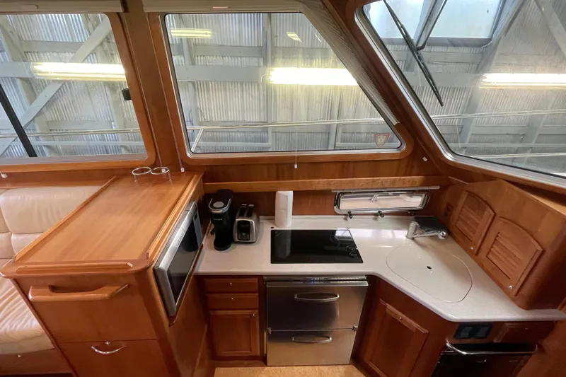  Yacht Photos Pics 2014 Sabre 42 Salon Express galley with wood cabinetry, appliances, and large windows.