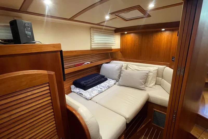  Yacht Photos Pics 2014 Sabre 42 Salon Express interior with cozy seating and wooden accents.