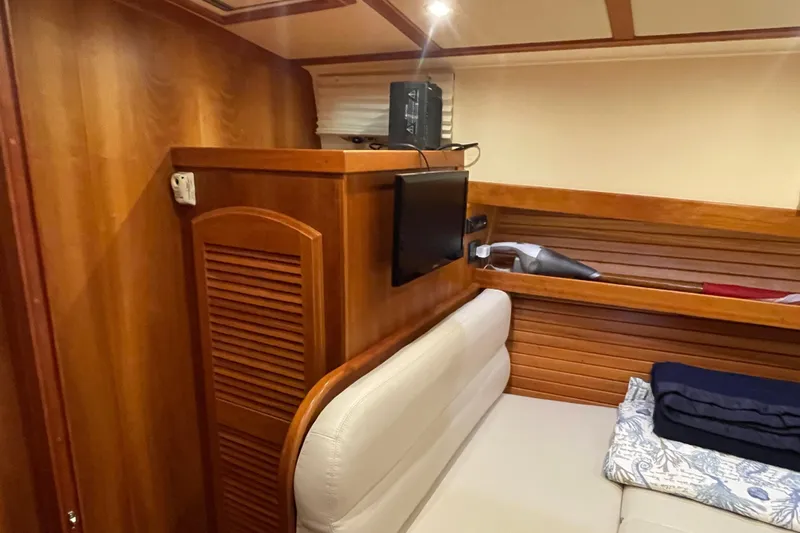  Yacht Photos Pics 2014 Sabre 42 Salon Express interior with wood paneling and compact TV setup.