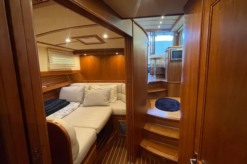  Yacht Photos Pics Luxurious interior of 2014 Sabre 42 Salon Express yacht with cozy seating and wooden finishes.