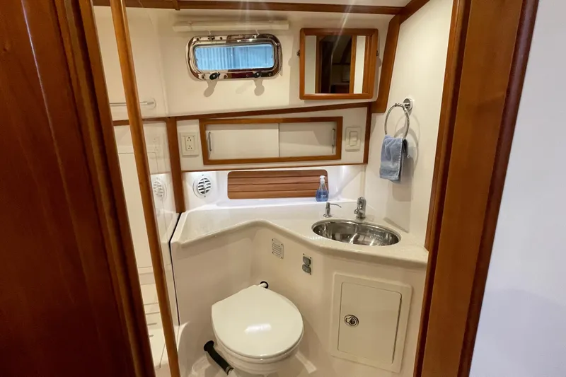  Yacht Photos Pics 2014 Sabre 42 Salon Express bathroom with sink, toilet, and wooden accents.