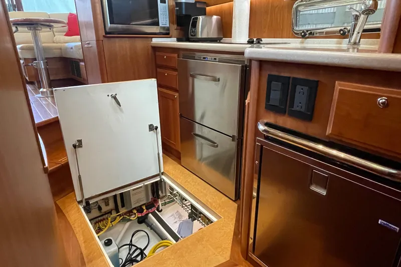  Yacht Photos Pics 2014 Sabre 42 Salon Express yacht kitchen with open floor hatch and modern appliances.