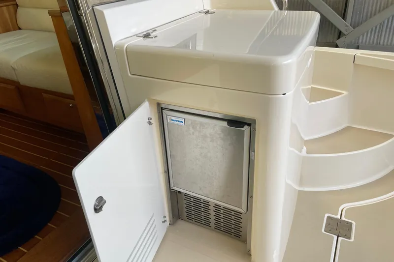  Yacht Photos Pics 2014 Sabre 42 Salon Express interior with open cabinet and built-in appliance.